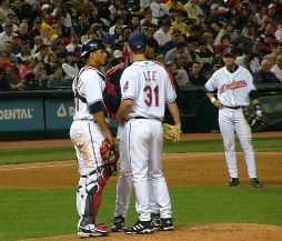Pitcher, catcher and manager meeting on mound