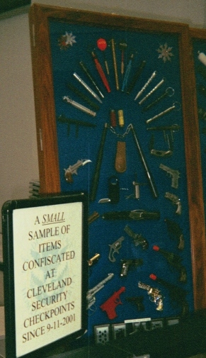 Sign reads "A small sample of items confiscated at Cleveland Security checkpoints since 9-11-2001"